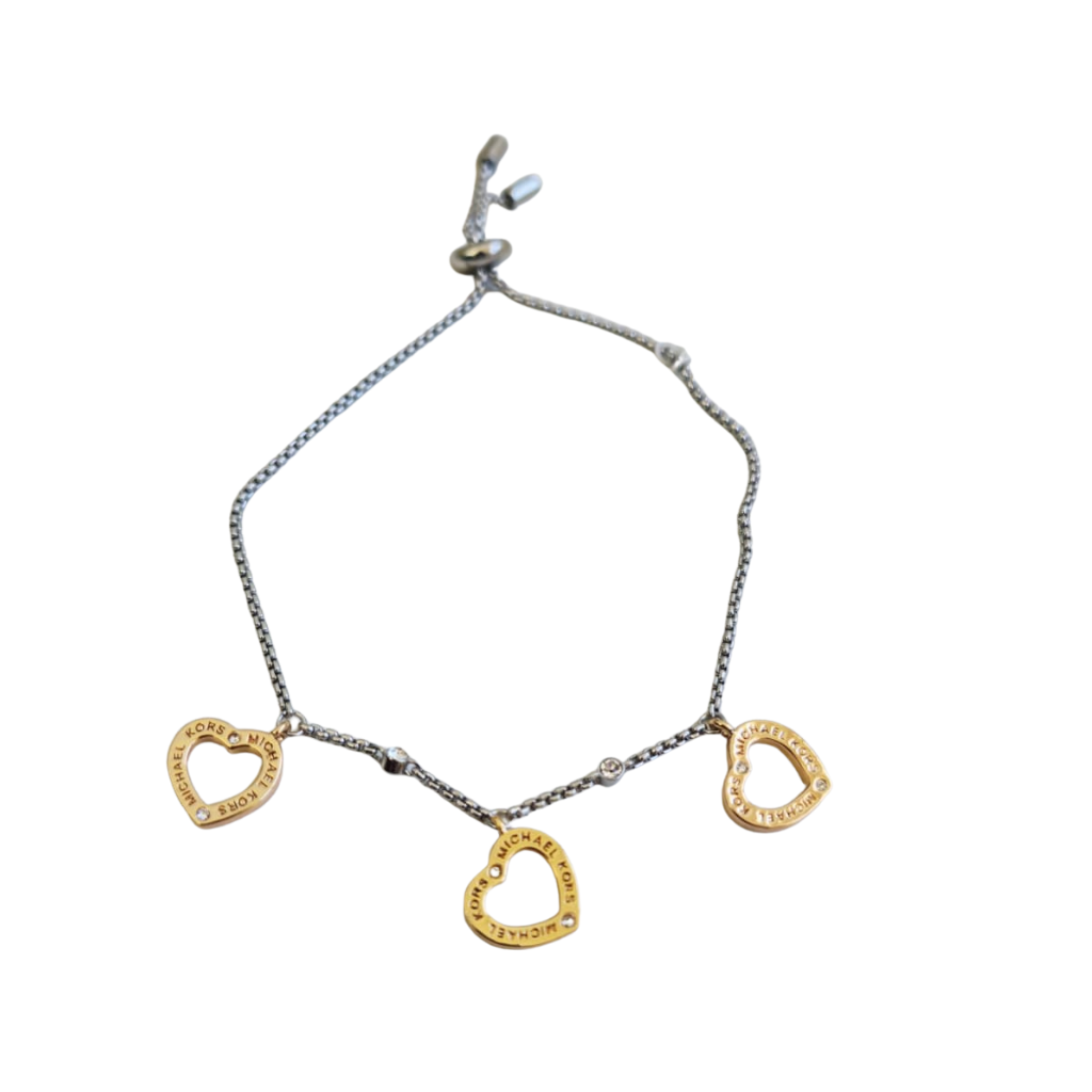 Pulsera Michael Kors plateada con dijes de corazón dorados